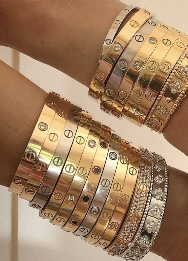 Cartier love bracelet stack showing on two arms 