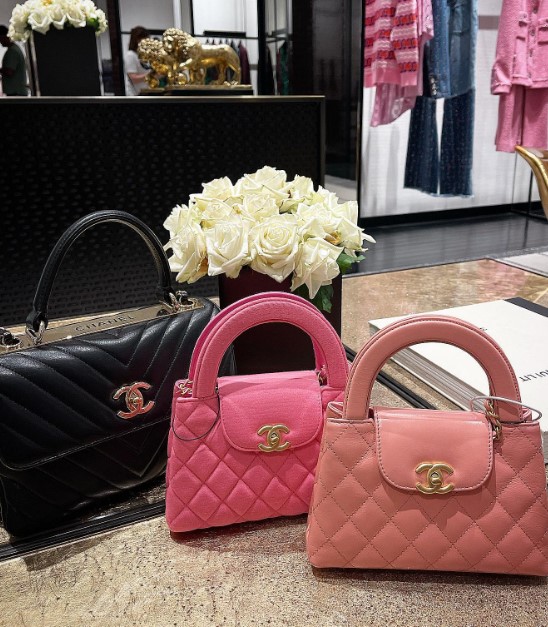 light pink and hot pink chanel kelly bags in a chanel store