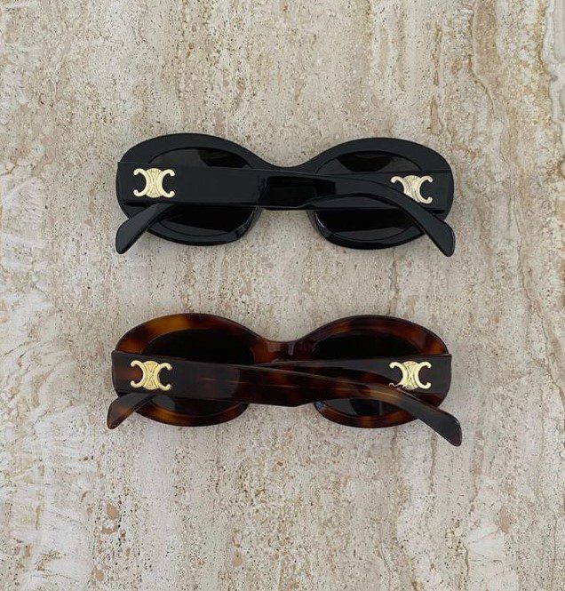 Celine Tortoise and Black Sunglasses lying on marble table