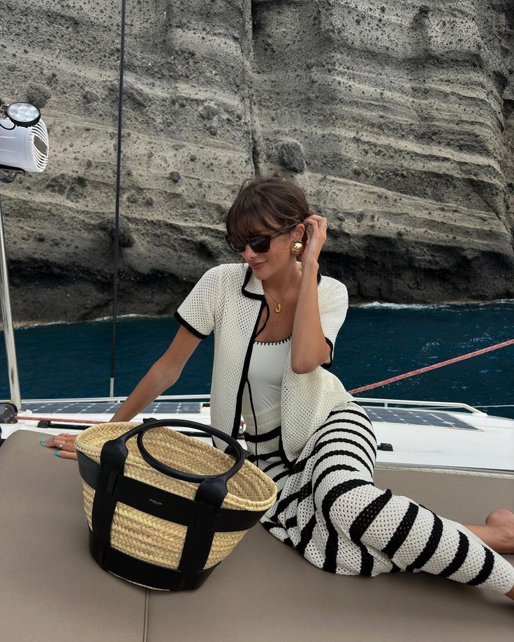 Girl on a boat carrying summer raffia tote basket beach bag 