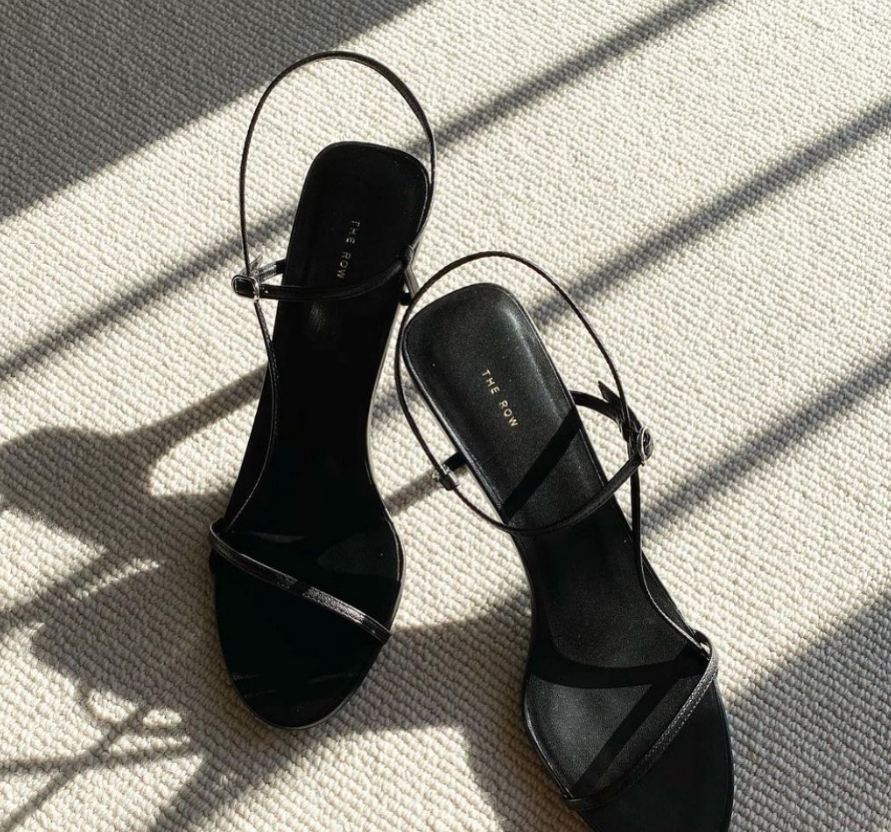 the row bare sandals in black on the floor