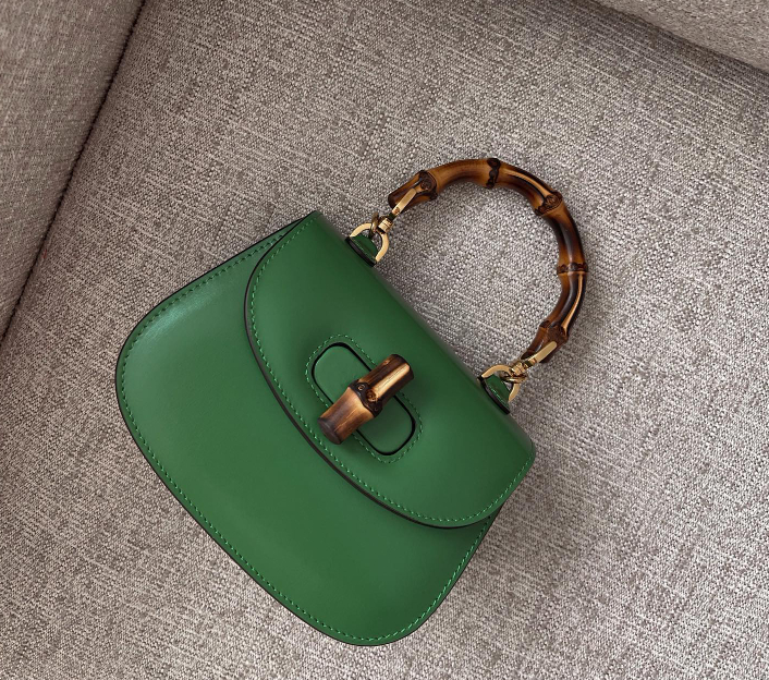 Green Gucci Bamboo 1947 mini top handle on a chair