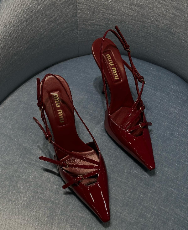 Dark red Miu Miu Slingback Buckle Heels on a chair