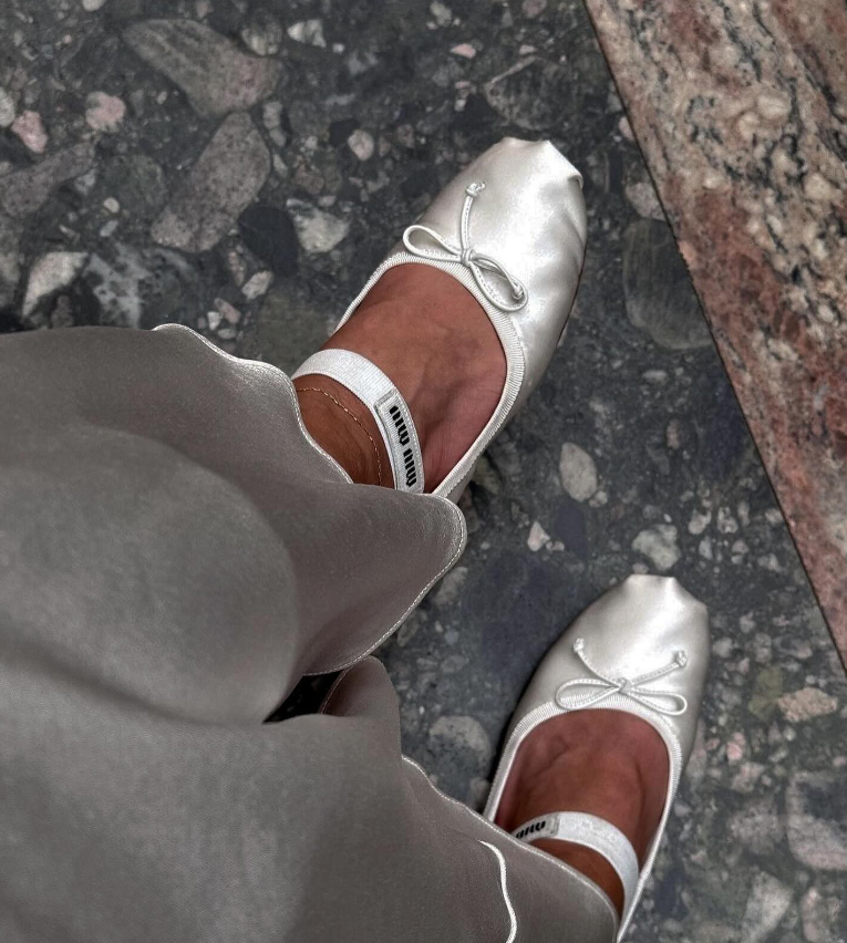 Miu Miu Ballet Flats in white satin being worn